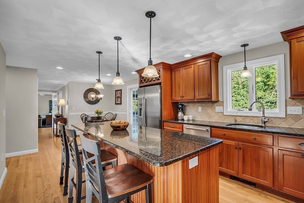 8 Peach Tree Path Andover, MA 01810 - Photo 8 of 41 a kitchen with a table chairs sink and cabinets