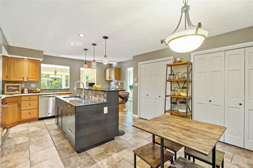 114 Will Scarlet Road Canonsburg, PA 15317 - Photo 8 of 14 a kitchen with stainless steel appliances kitchen island granite countertop a table chairs sink and cabinets