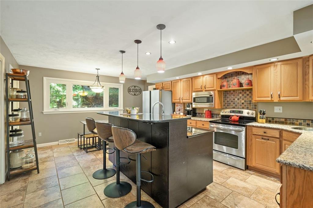 114 Will Scarlet Road Canonsburg, PA 15317 - Photo 9 of 14 a kitchen with stainless steel appliances granite countertop a stove and a refrigerator