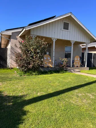 a view of a house with backyard and sitting area