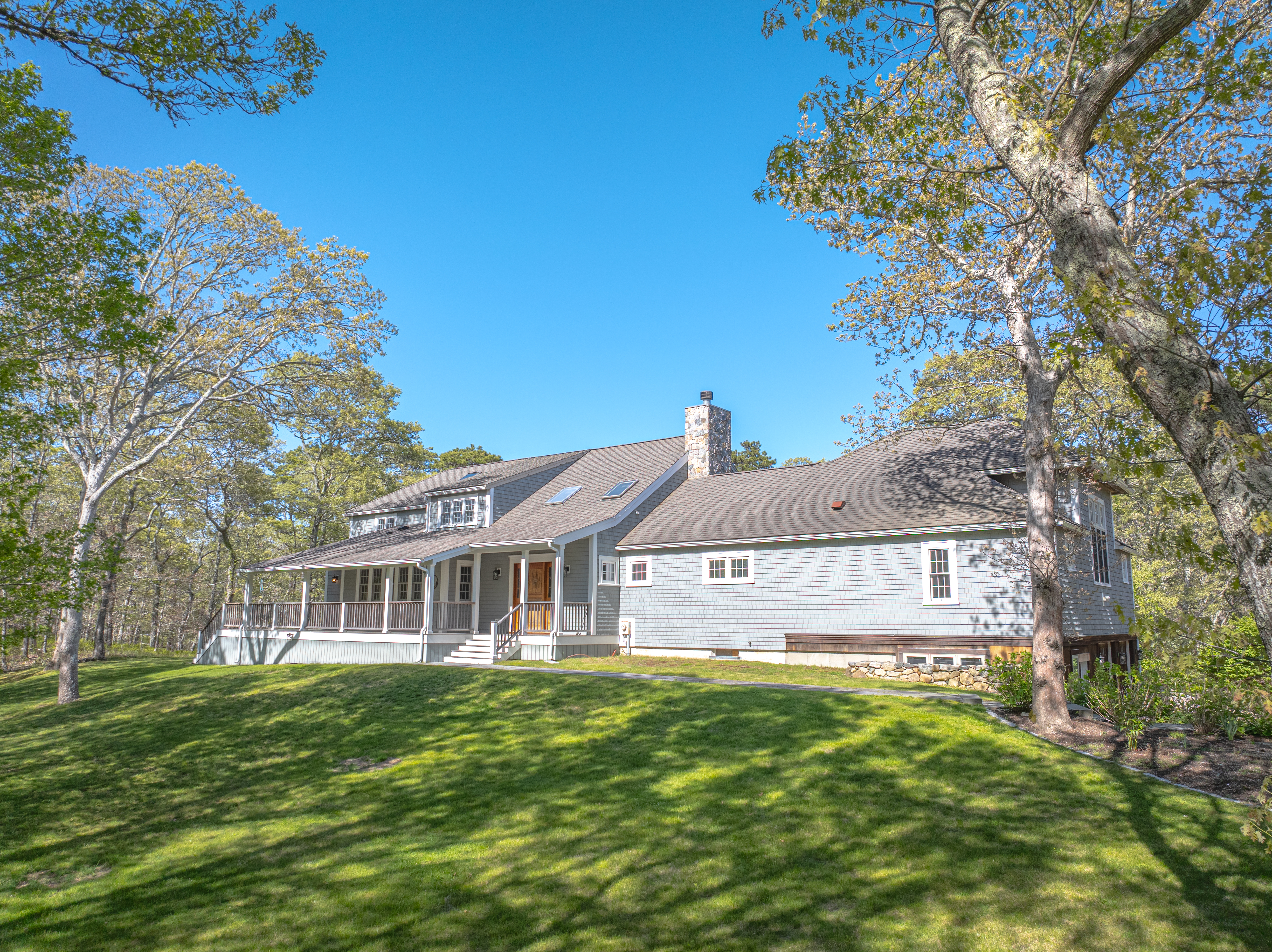 a front view of a house with a garden