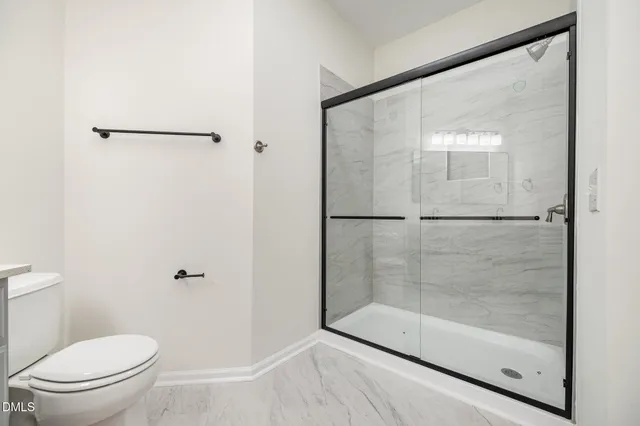 a bathroom with a glass shower door
