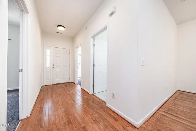 an empty room with wooden floor