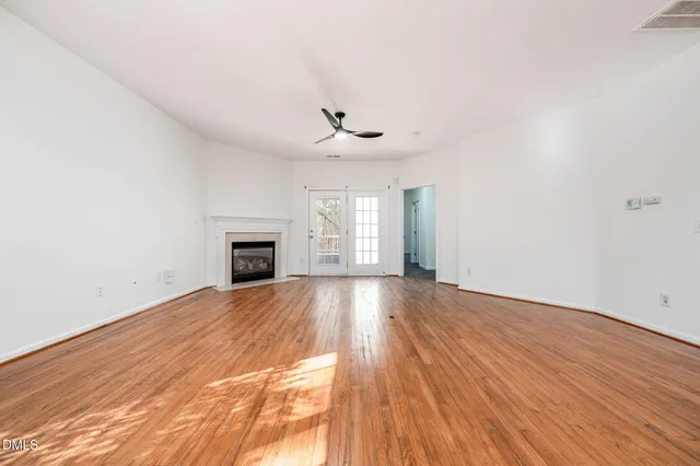 wooden floor in an empty room with a fireplace