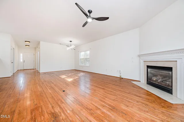 a view of an empty room and wooden floor