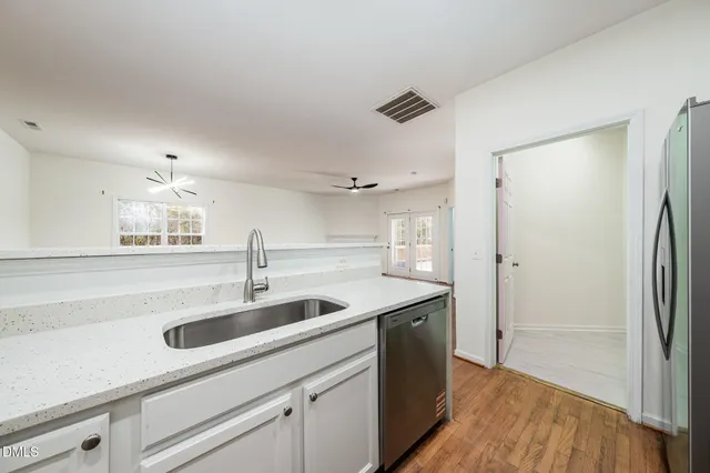a kitchen with a sink and a refrigerator