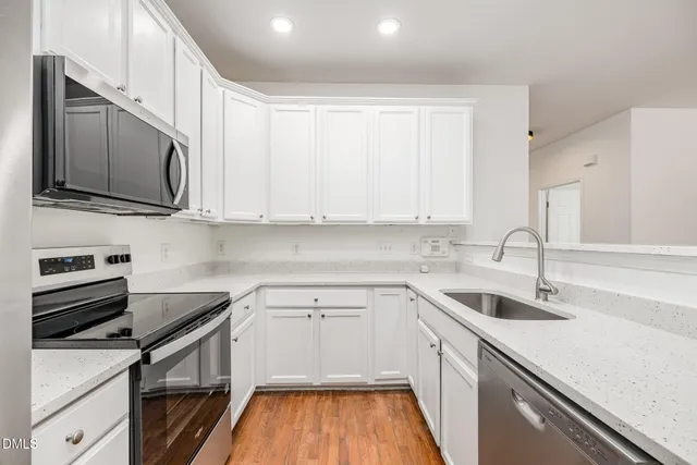 a kitchen with a sink stove and microwave