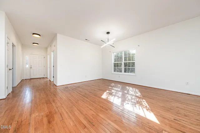 wooden floor in an empty room with a window