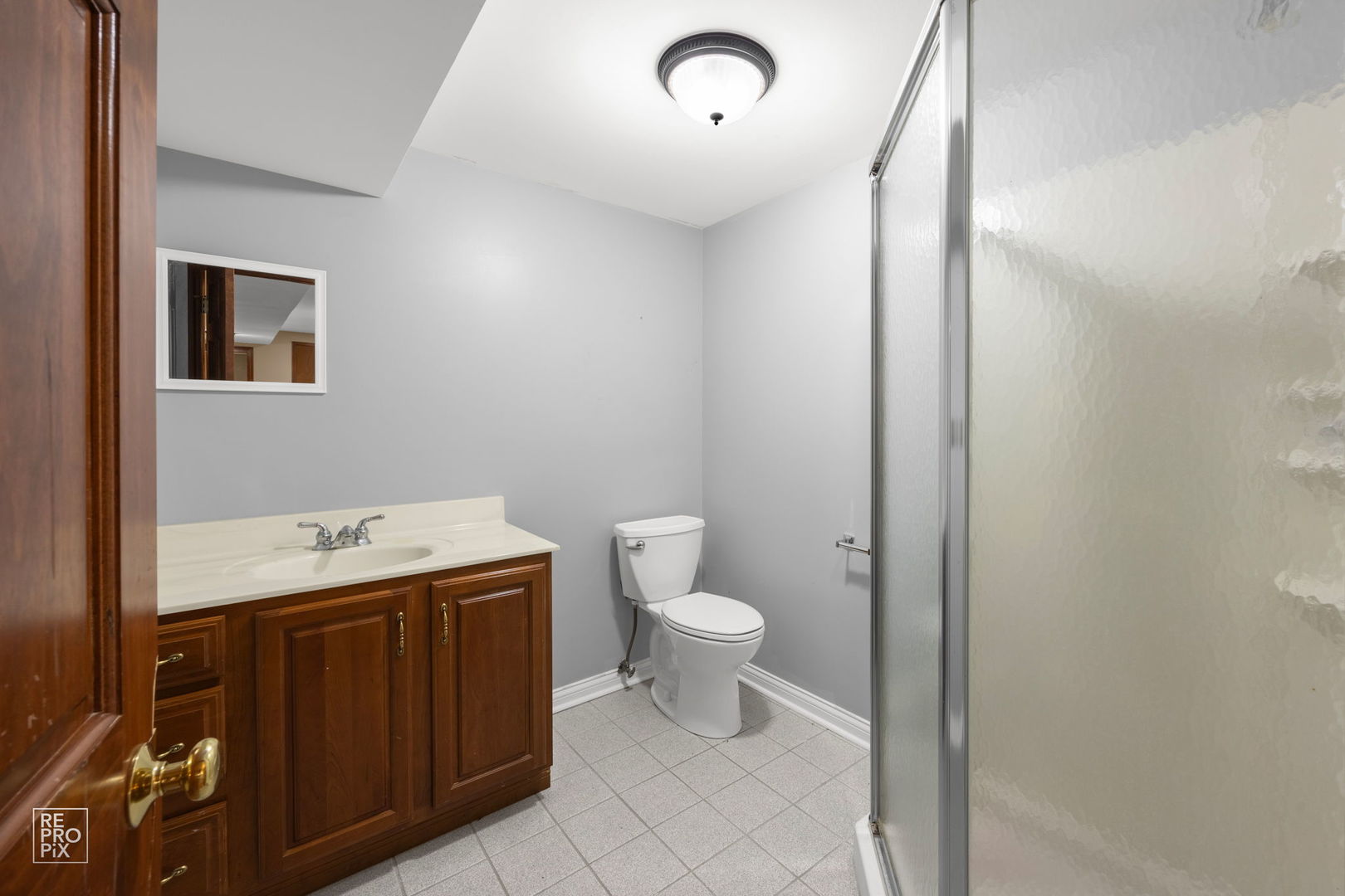 602 Bailey Drive Batavia, IL 60510 - Photo 24 of 26 a bathroom with a sink a toilet and a mirror