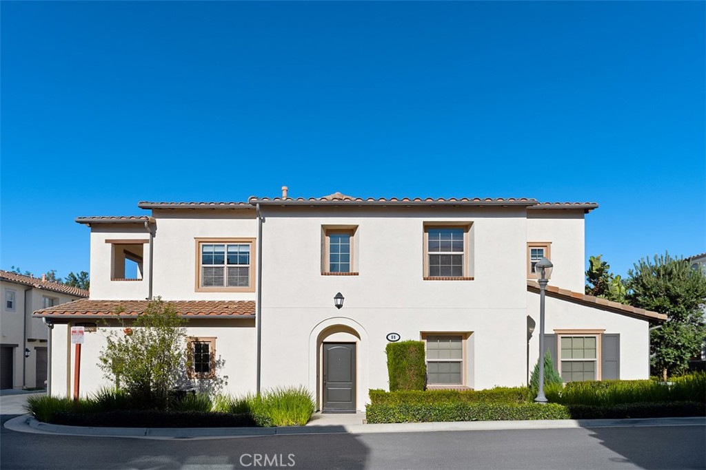 96 Talisman, Unit 23 Irvine, CA 92620 - Photo 1 of 43 a front view of a house with garden