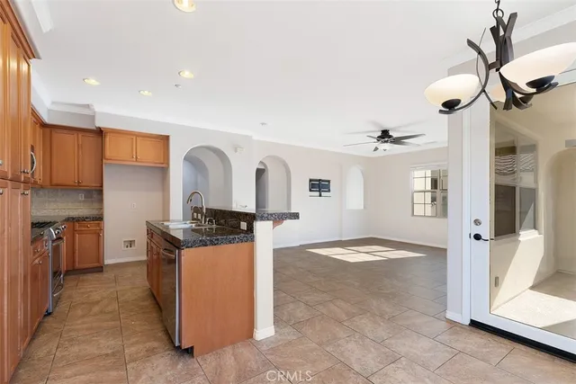 a view of a kitchen with stainless steel appliances granite countertop a stove and a refrigerator