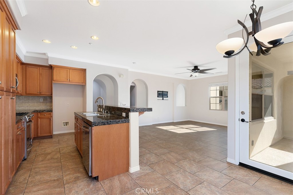 96 Talisman, Unit 23 Irvine, CA 92620 - Photo 11 of 43 a view of a kitchen with stainless steel appliances granite countertop a stove and a refrigerator