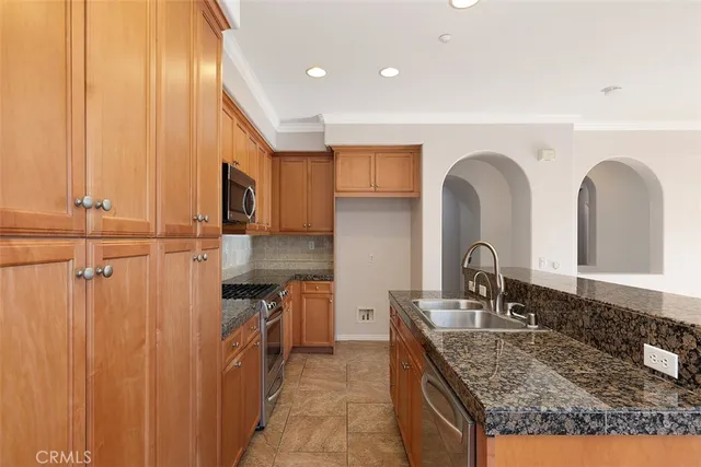 a kitchen with granite countertop a sink and cabinets