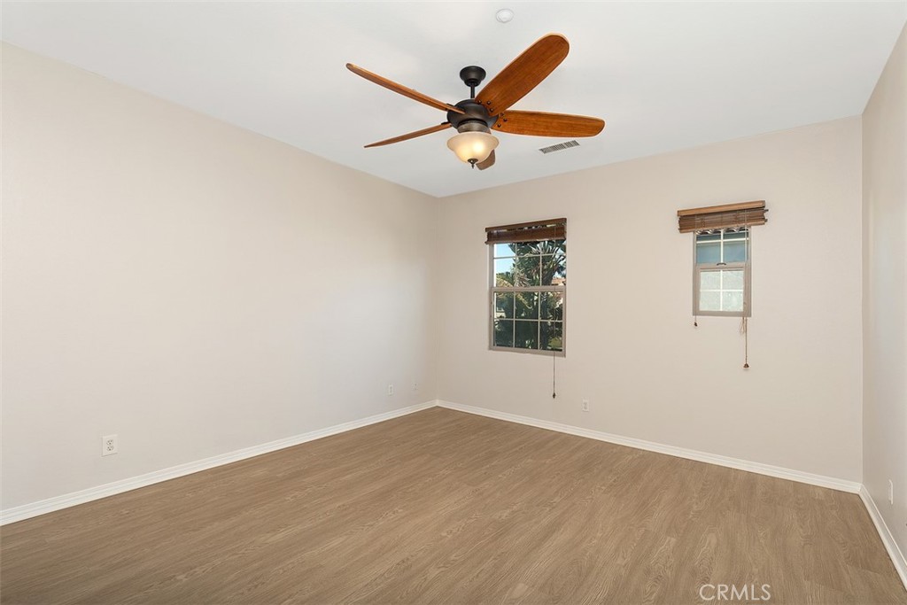 96 Talisman, Unit 23 Irvine, CA 92620 - Photo 18 of 43 an empty room with wooden floor and windows
