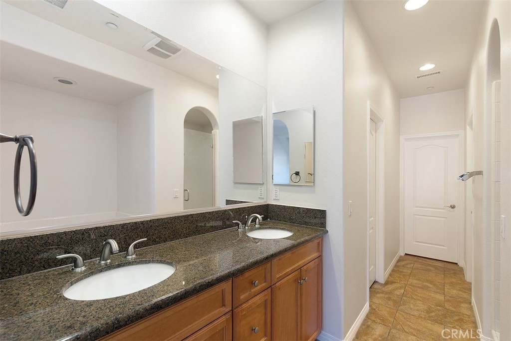 96 Talisman, Unit 23 Irvine, CA 92620 - Photo 20 of 43 a bathroom with a granite countertop sink and a mirror