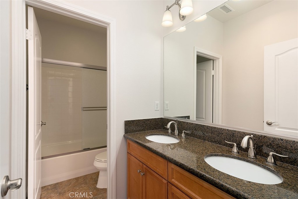 96 Talisman, Unit 23 Irvine, CA 92620 - Photo 23 of 43 a bathroom with a granite countertop sink toilet and shower