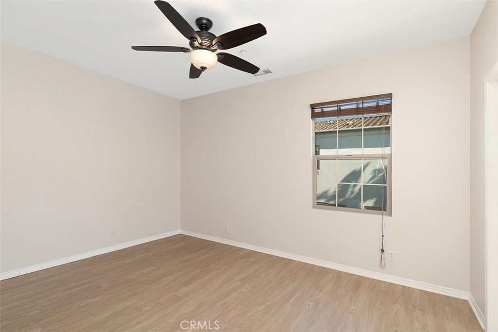 96 Talisman, Unit 23 Irvine, CA 92620 - Photo 24 of 43 an empty room with wooden floor and windows