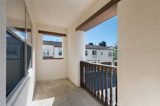 a view of a hallway to a livingroom with furniture