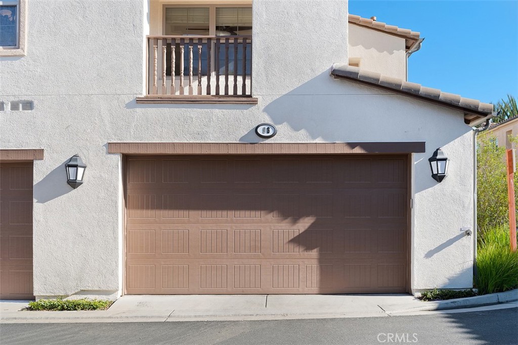 96 Talisman, Unit 23 Irvine, CA 92620 - Photo 27 of 43 a front view of a house with garage