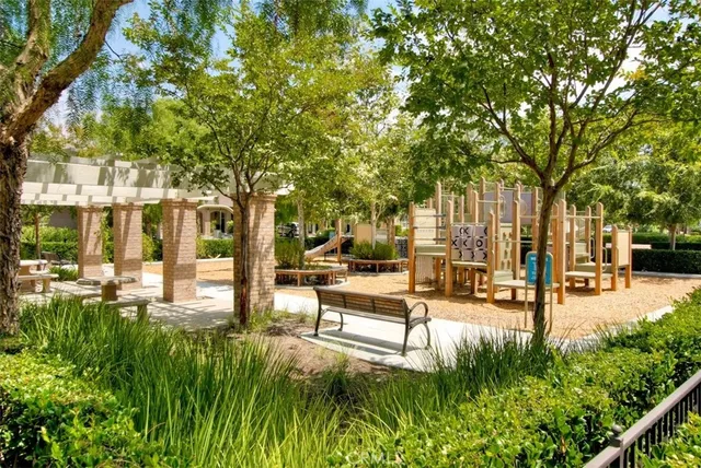 a view of a patio with table and chairs and a large tree