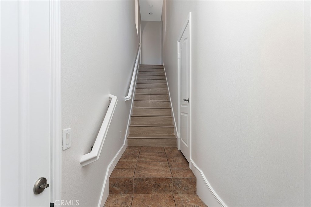 96 Talisman, Unit 23 Irvine, CA 92620 - Photo 5 of 43 a view of a hallway with wooden floor and entryway