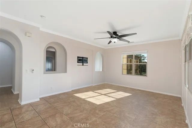 a view of a livingroom with a ceiling fan and window