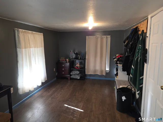 a view of a livingroom with furniture and a window