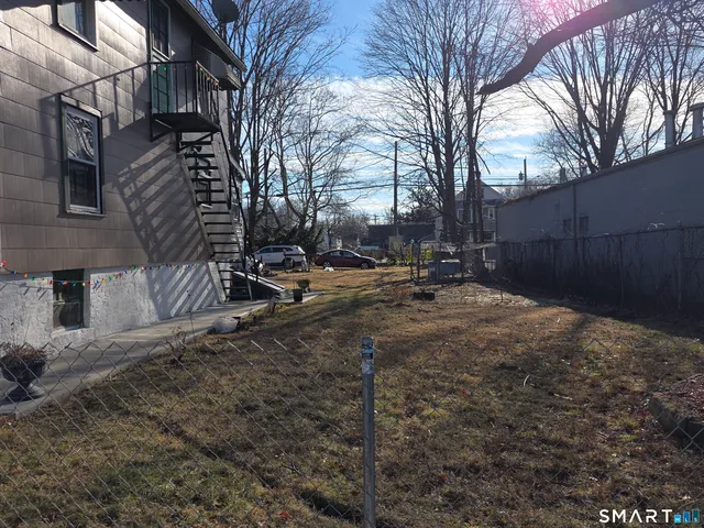 a backyard of a house with trees and houses