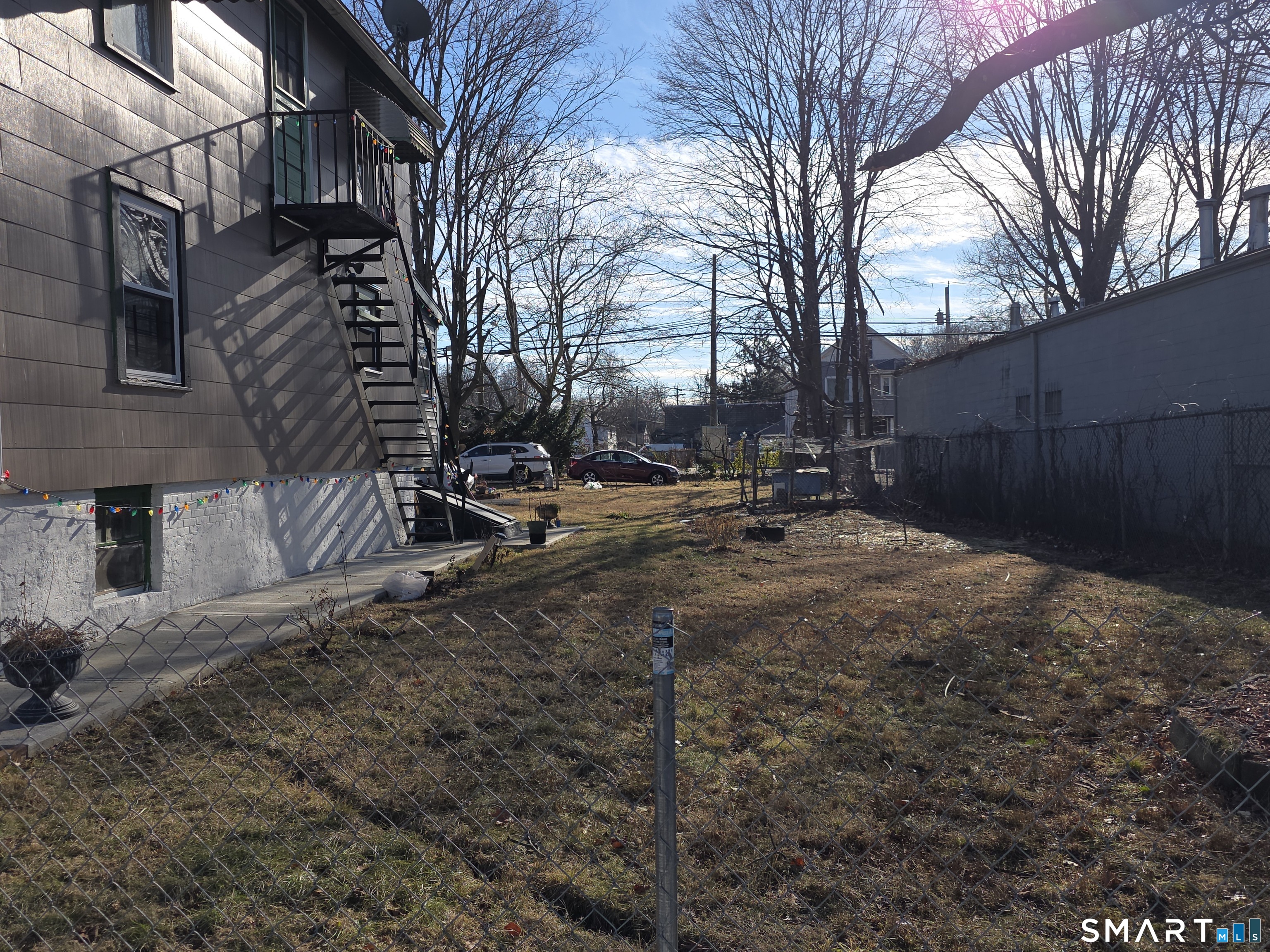 48 Alling Street Hamden, CT 06517 - Photo 4 of 23 a backyard of a house with trees and houses