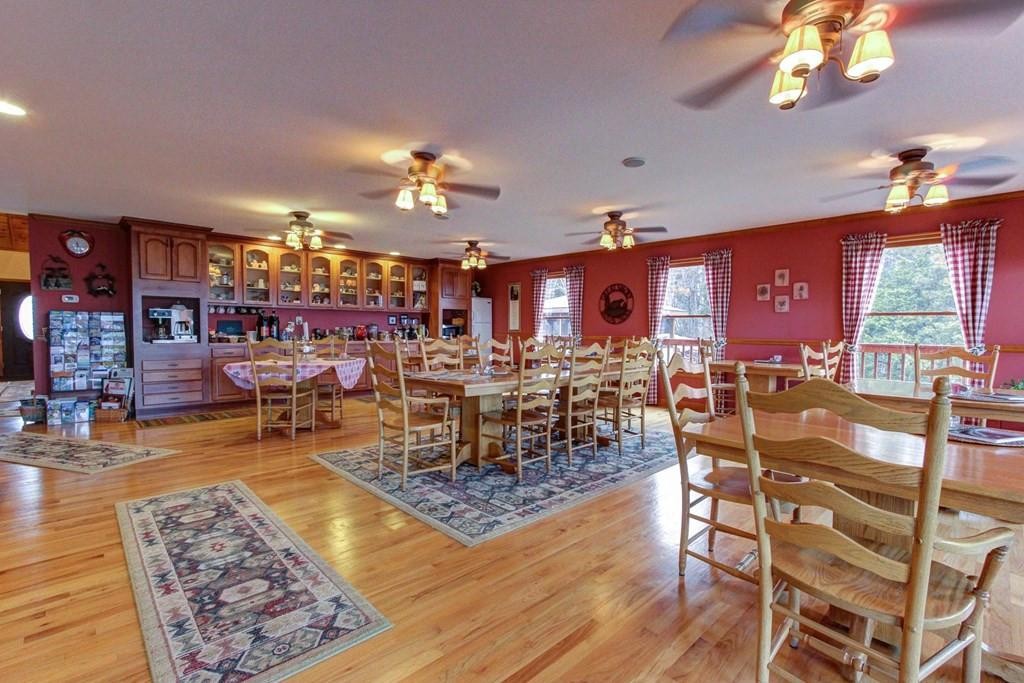 2149 Seaton Springs Road Sevierville, TN 37862 - Photo 21 of 26 a view of a dining room with furniture a chandelier and wooden floor