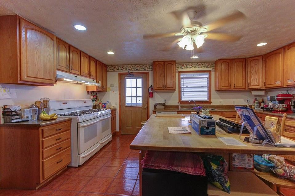 2149 Seaton Springs Road Sevierville, TN 37862 - Photo 6 of 26 a kitchen with kitchen island granite countertop a sink cabinets and stainless steel appliances