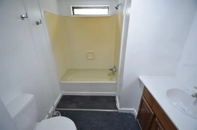 an empty room with a empty space and windows