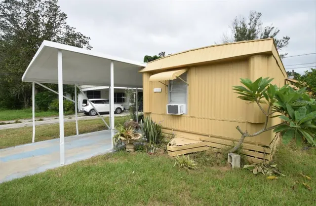 a view of a backyard with table and chairs and potted plants