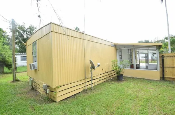 a backyard of a house with a tree