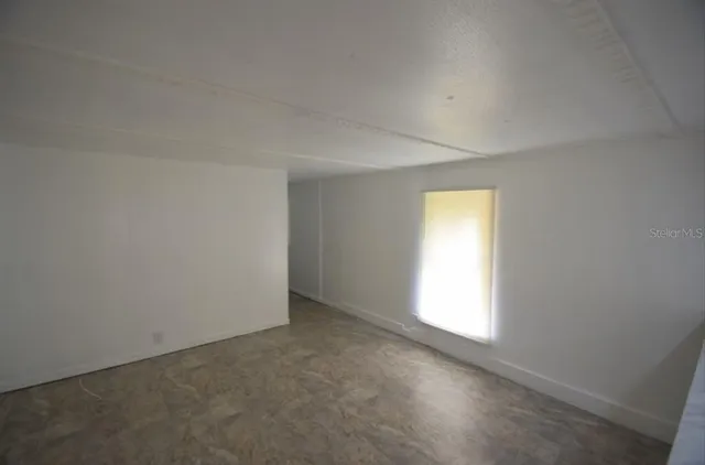 a view of a kitchen with a sink and cabinets