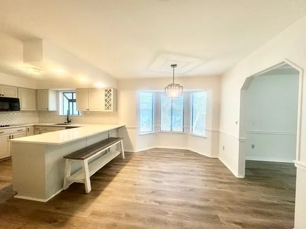 a large kitchen with kitchen island a sink stainless steel appliances and cabinets