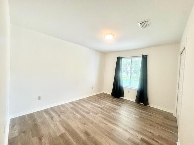 708 Caribbean Way Niceville, FL 32578 - Photo 17 of 34 a view of empty room with wooden floor and fan