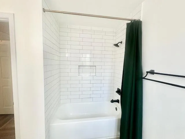 a bathroom with a shower and a bath tub