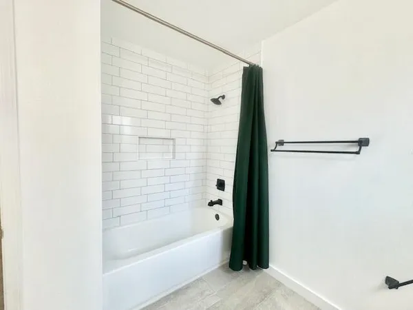 a bathroom with a bathtub and shower