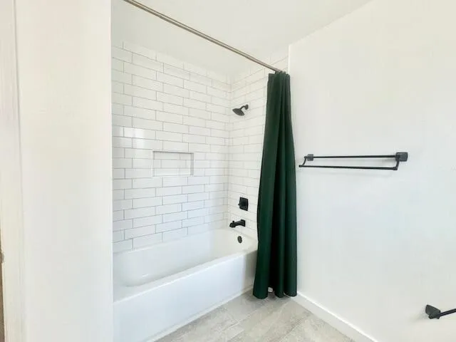 a bathroom with a bathtub and shower