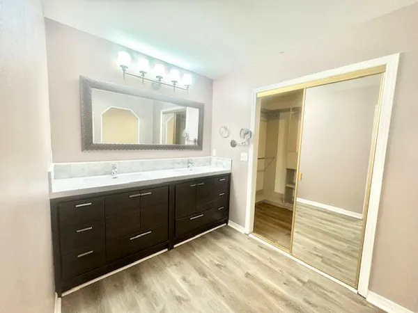 a spacious bathroom with a double vanity sink and a mirror