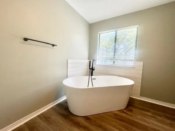 a white bath tub sitting in a bathroom