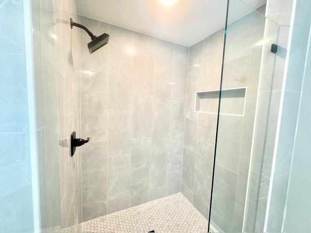 708 Caribbean Way Niceville, FL 32578 - Photo 26 of 34 a bathroom with a shower and a glass door