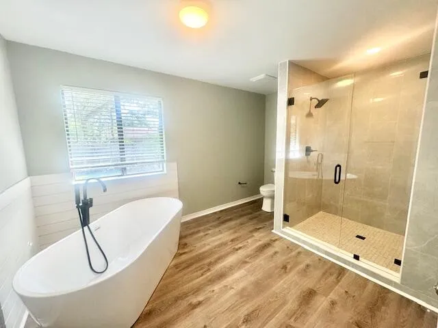 a bath room with a bath tub and a shower