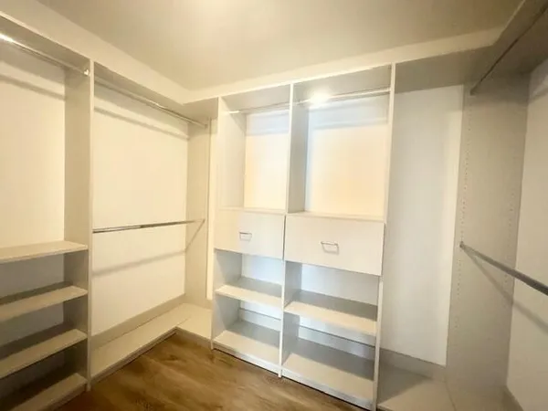a view of walk in closet with empty racks