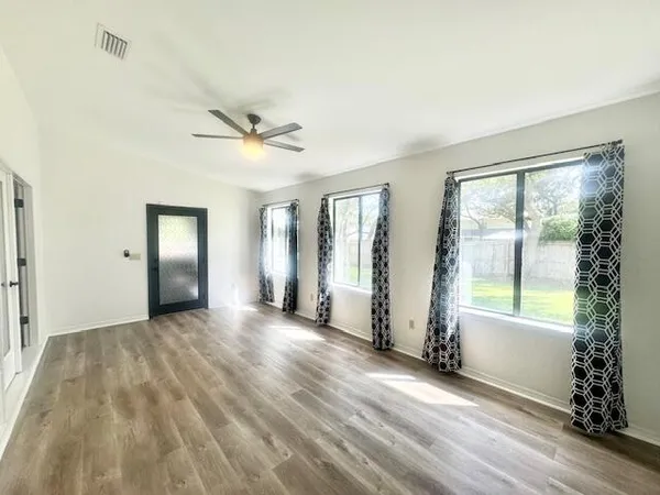 a view of a livingroom with a ceiling fan and window
