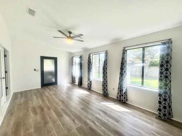a view of a livingroom with a ceiling fan and window