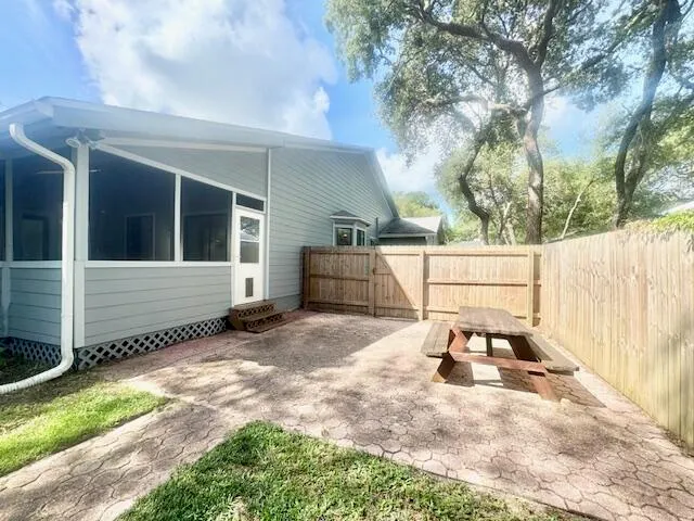 a white house that has tree in front of it