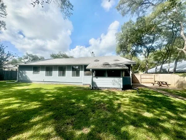 a backyard of a house with table and chairs