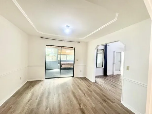 wooden floor in an empty room with a window